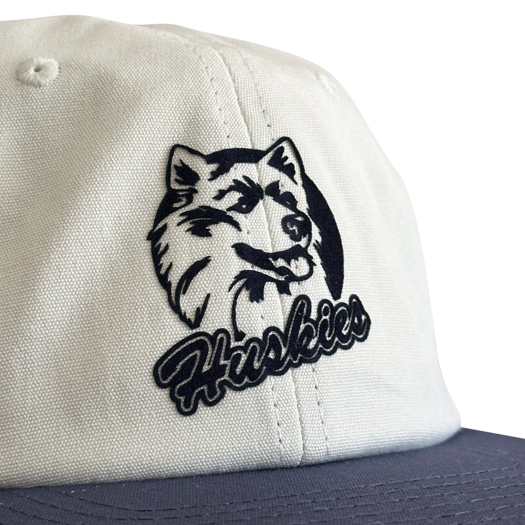 Vintage UConn Huskies Hat | 6 Panel Strapback Hat in white with a navy brim and detailed Husky logo patch.