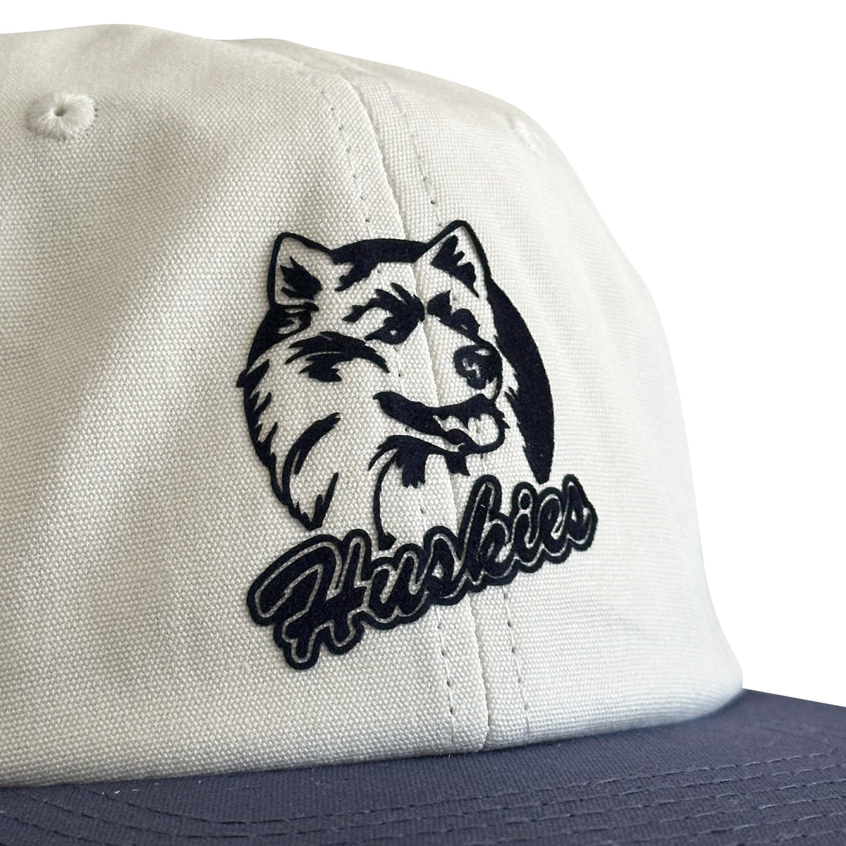 Vintage UConn Huskies Hat | 6 Panel Strapback Hat in white with a navy brim and detailed Husky logo patch.