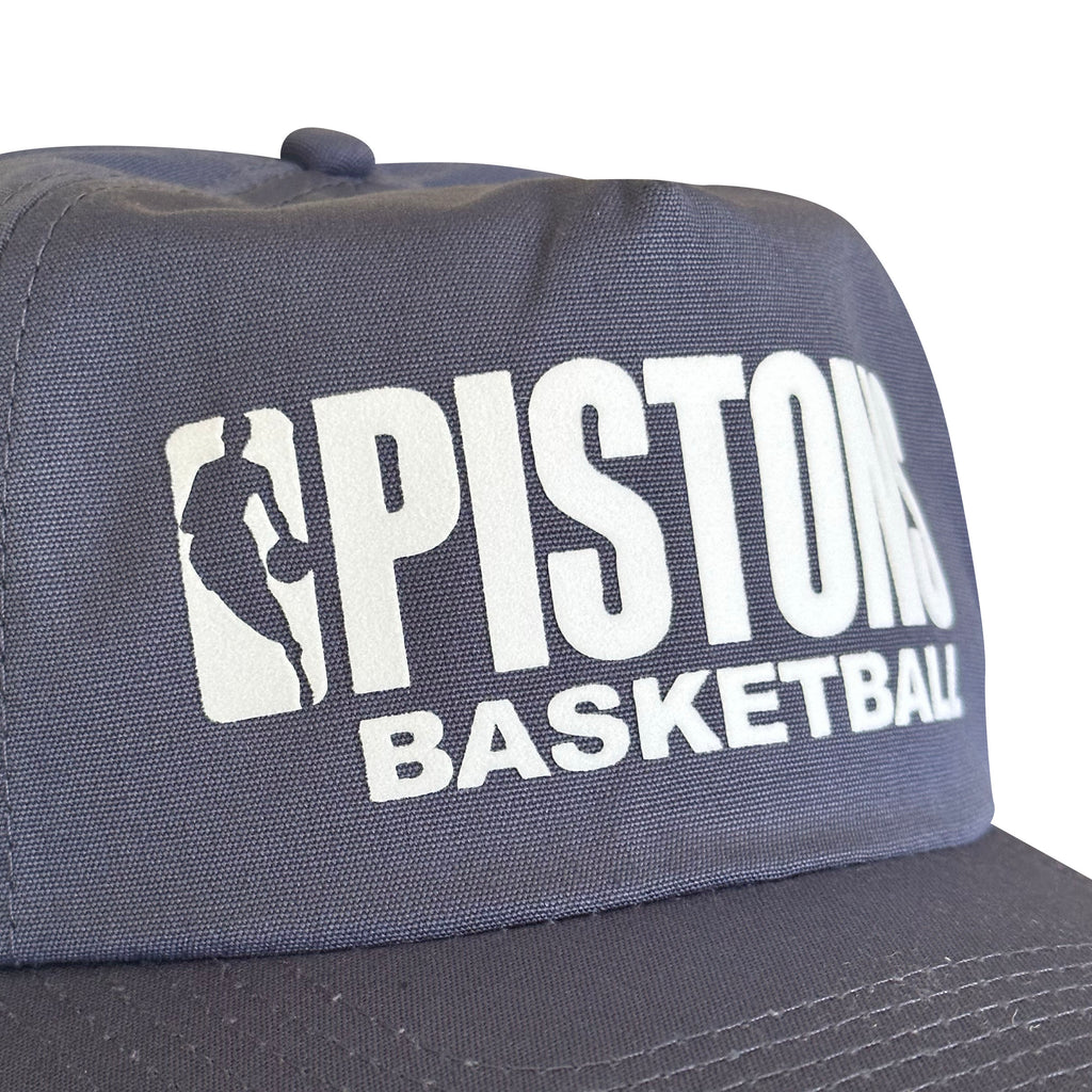 Vintage Detroit Pistons Basketball Hat | 5 Panel Snapback Hat in navy with bold white Pistons Basketball lettering and basketball logo patch.