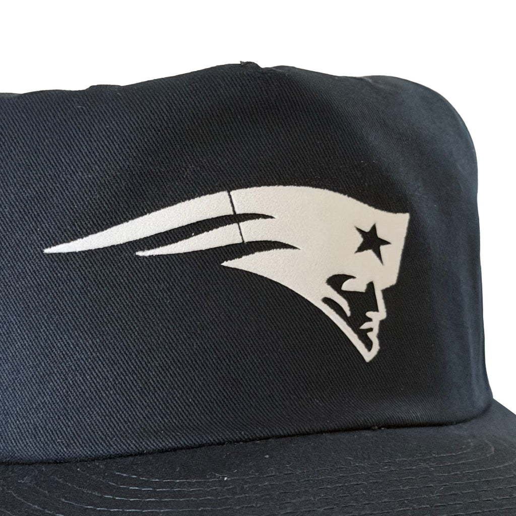 Vintage New England Patriots Hat | 5 Panel Snapback Hat, black cap with a white Patriots logo on the front from My Store